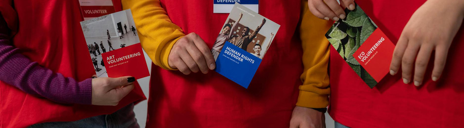 Image of individuals holding different types of business leaflets with different designs