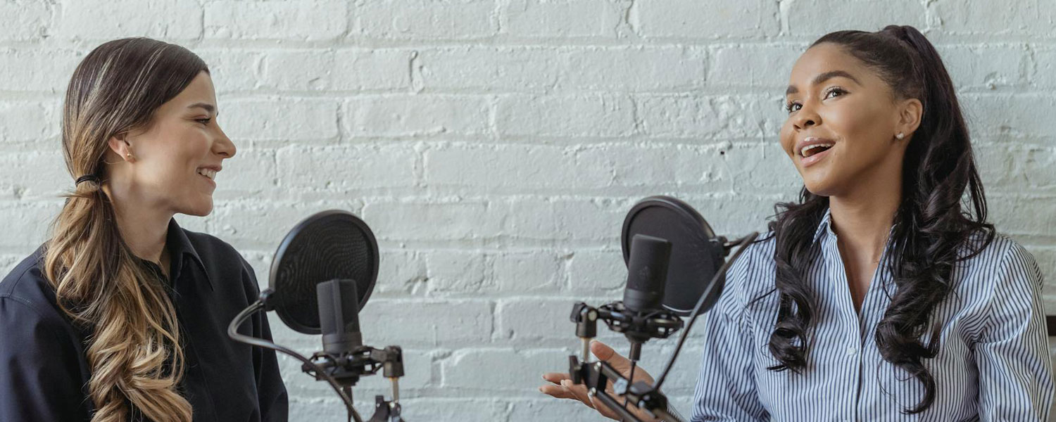 Two girls are discussing on a new product's benefits using podcast setup